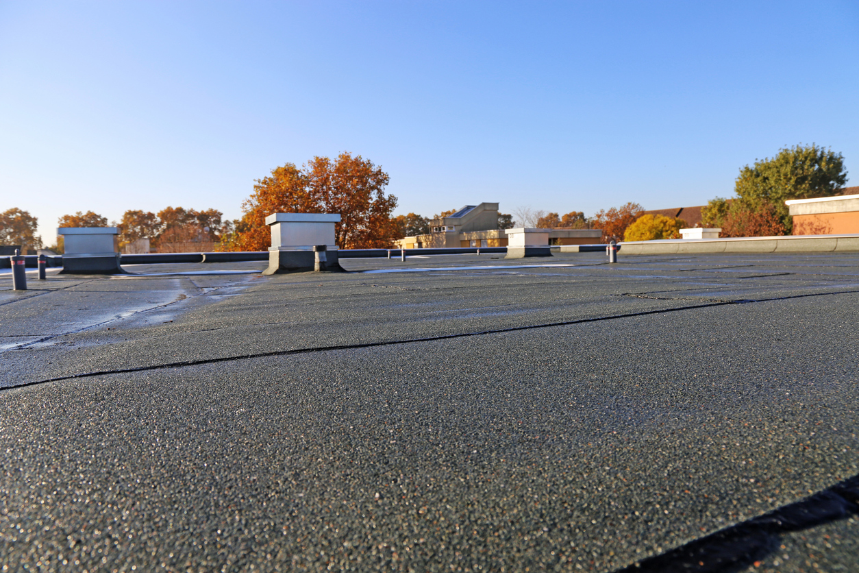 Building with newly renovated flat roof sealing