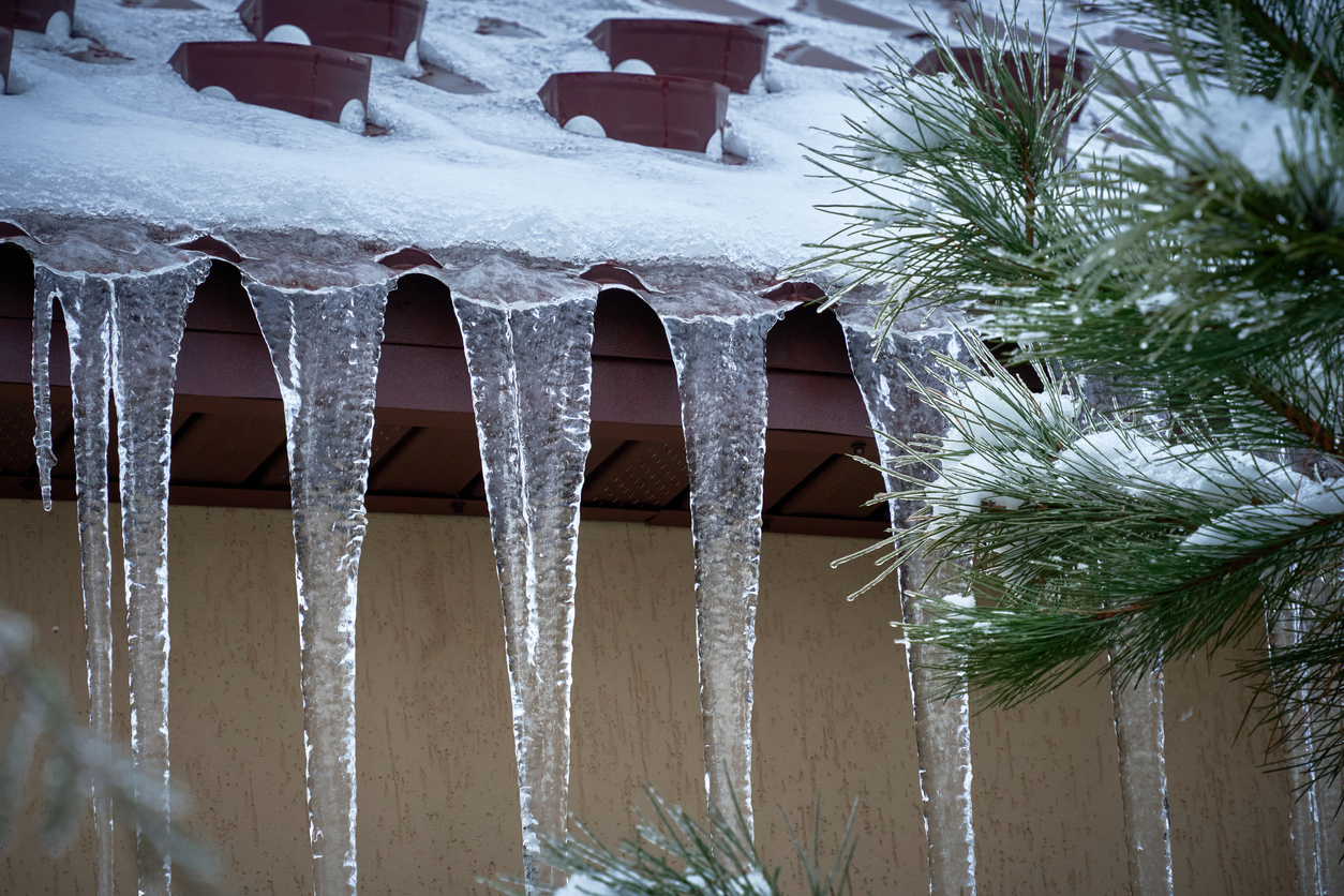 pd home exteriors fixing damaged roofs, ice dam image of ice from roof